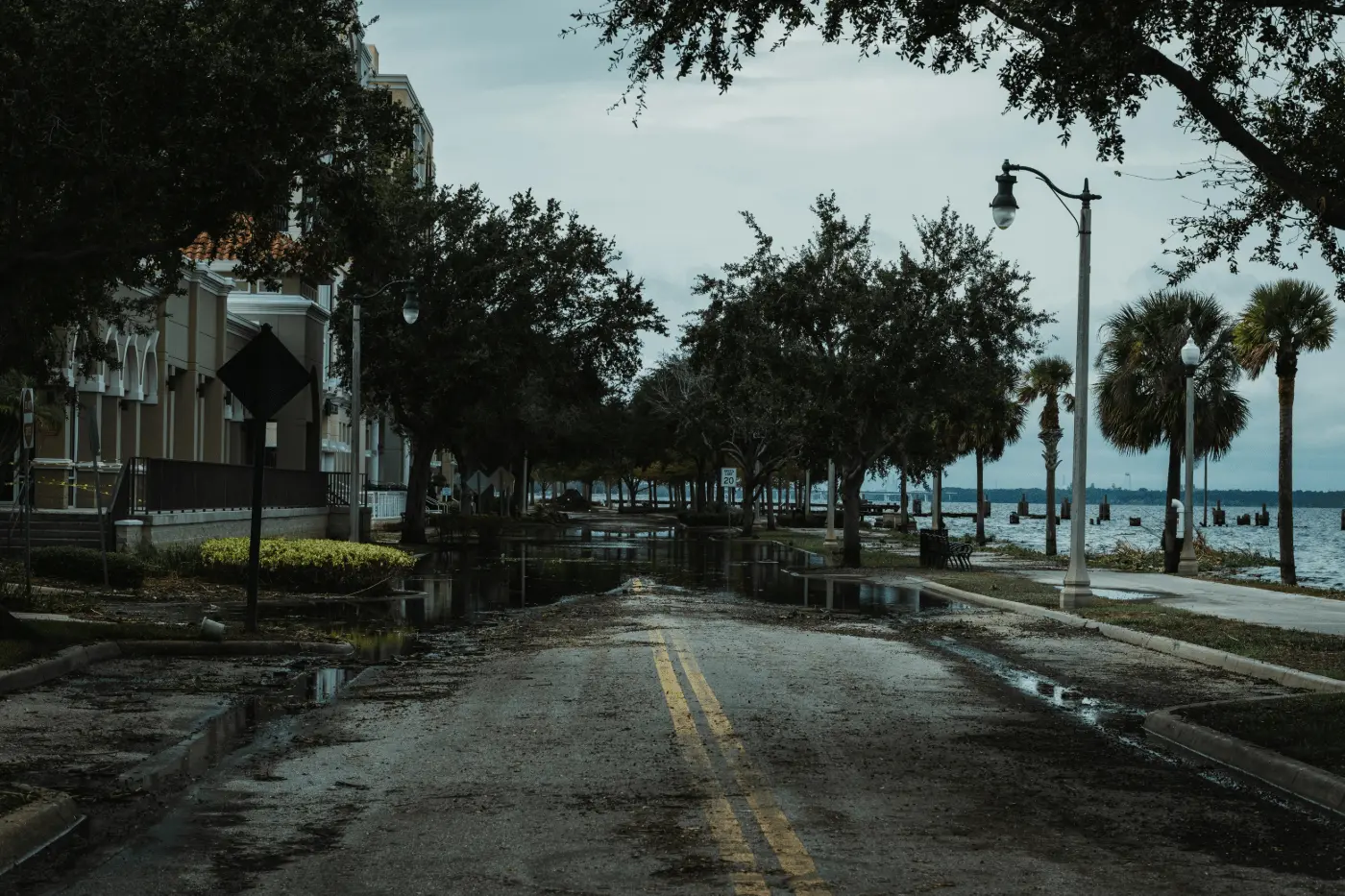 A quiet riverfront residential street in New Port Richey showing debris after a Gulf Coast storm surge