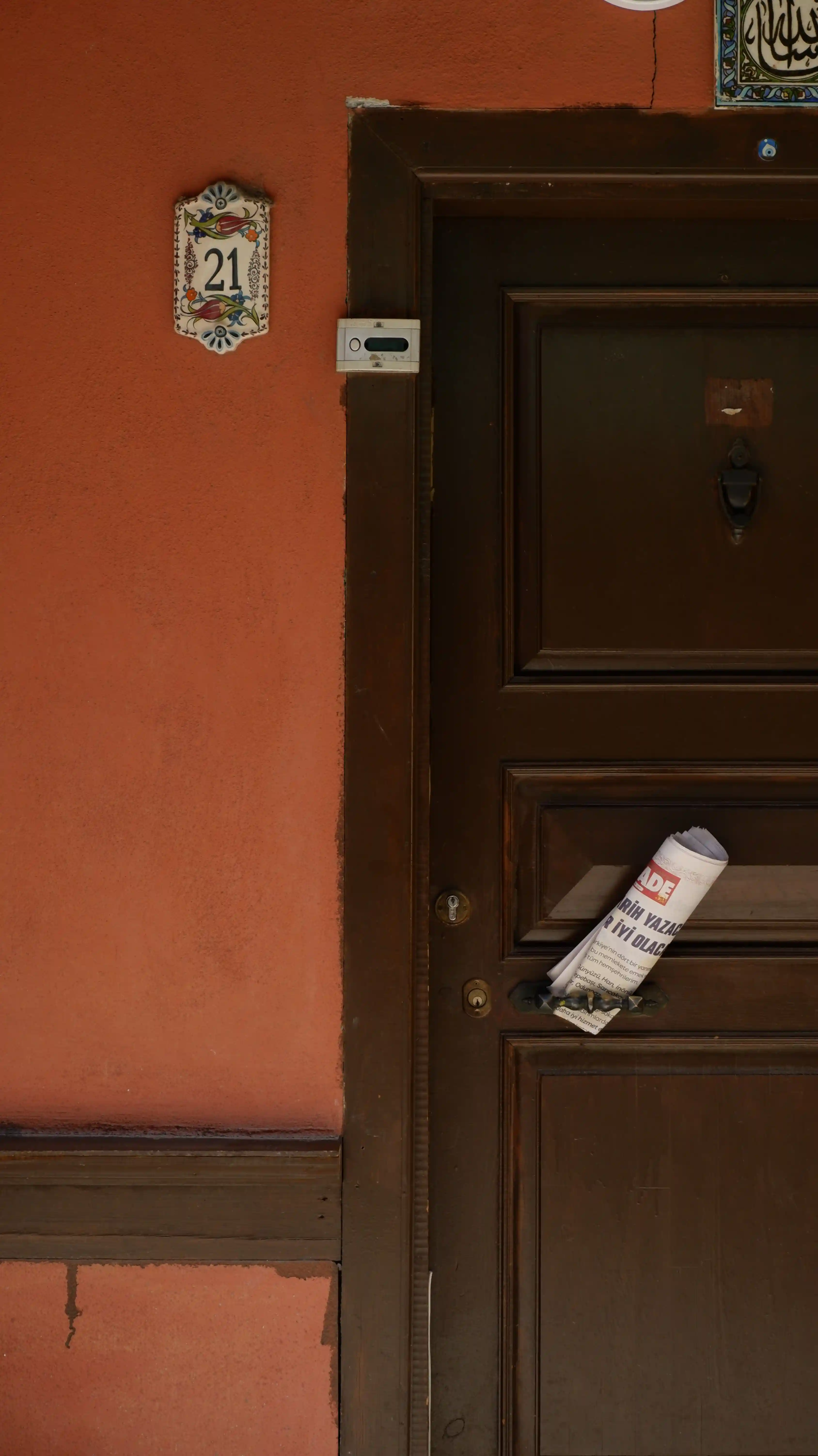A past due rent notice taped to the front door of a distressed rental property