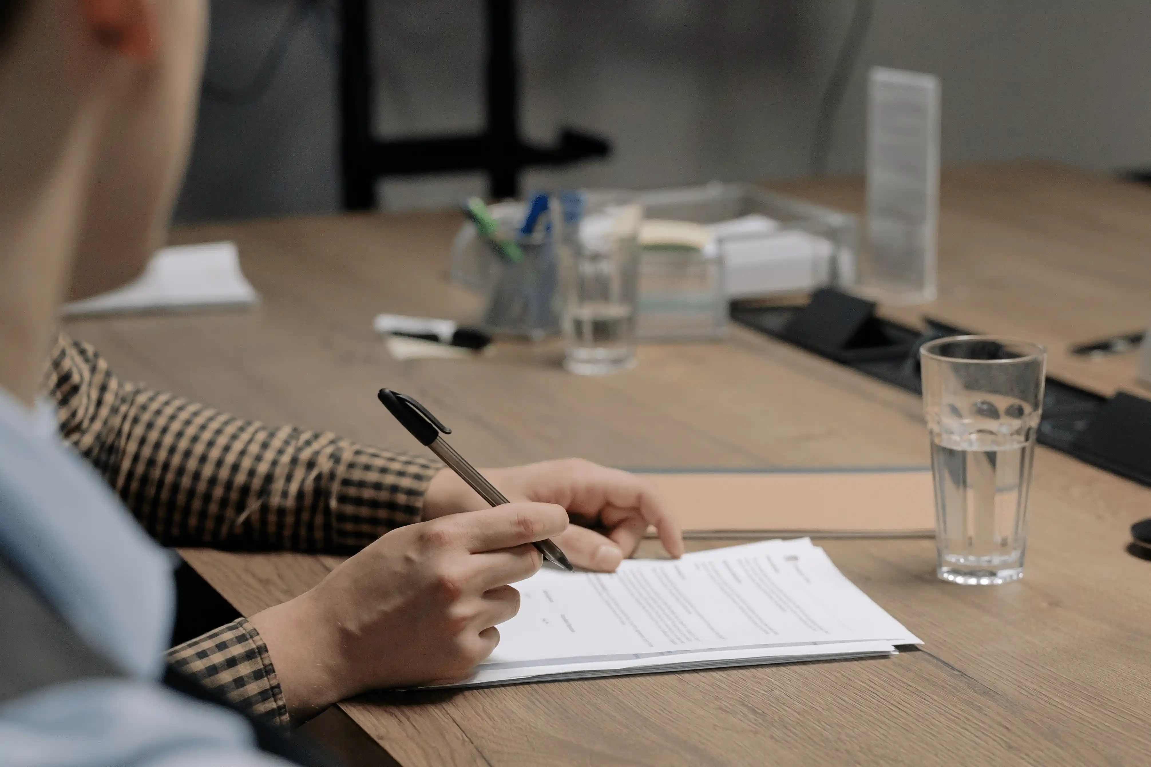 A person reviewing legal probate documents and estate paperwork at a desk