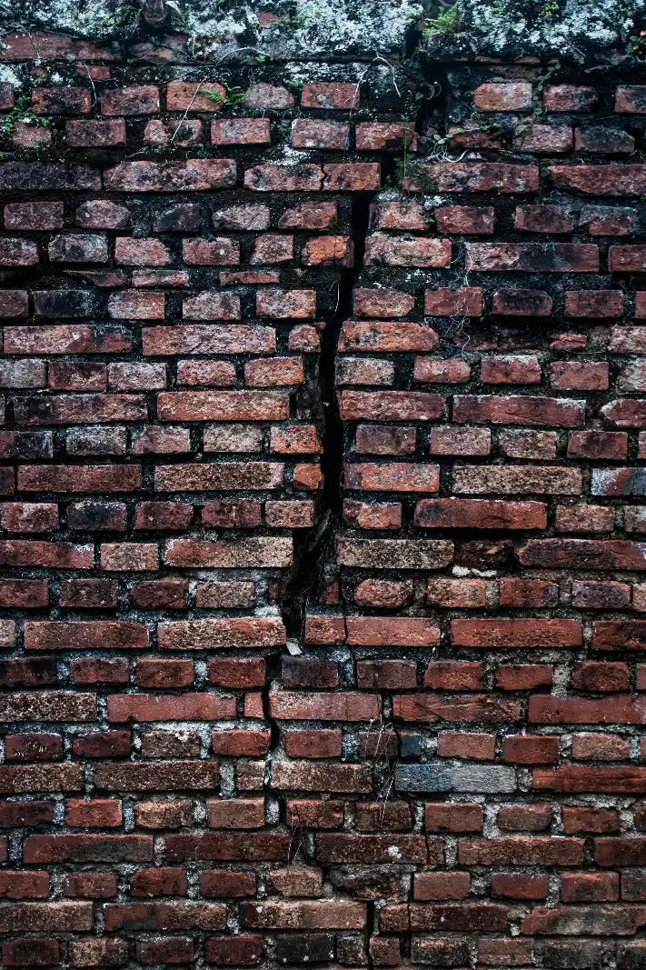 Water damage and structural cracking along a residential canal seawall
