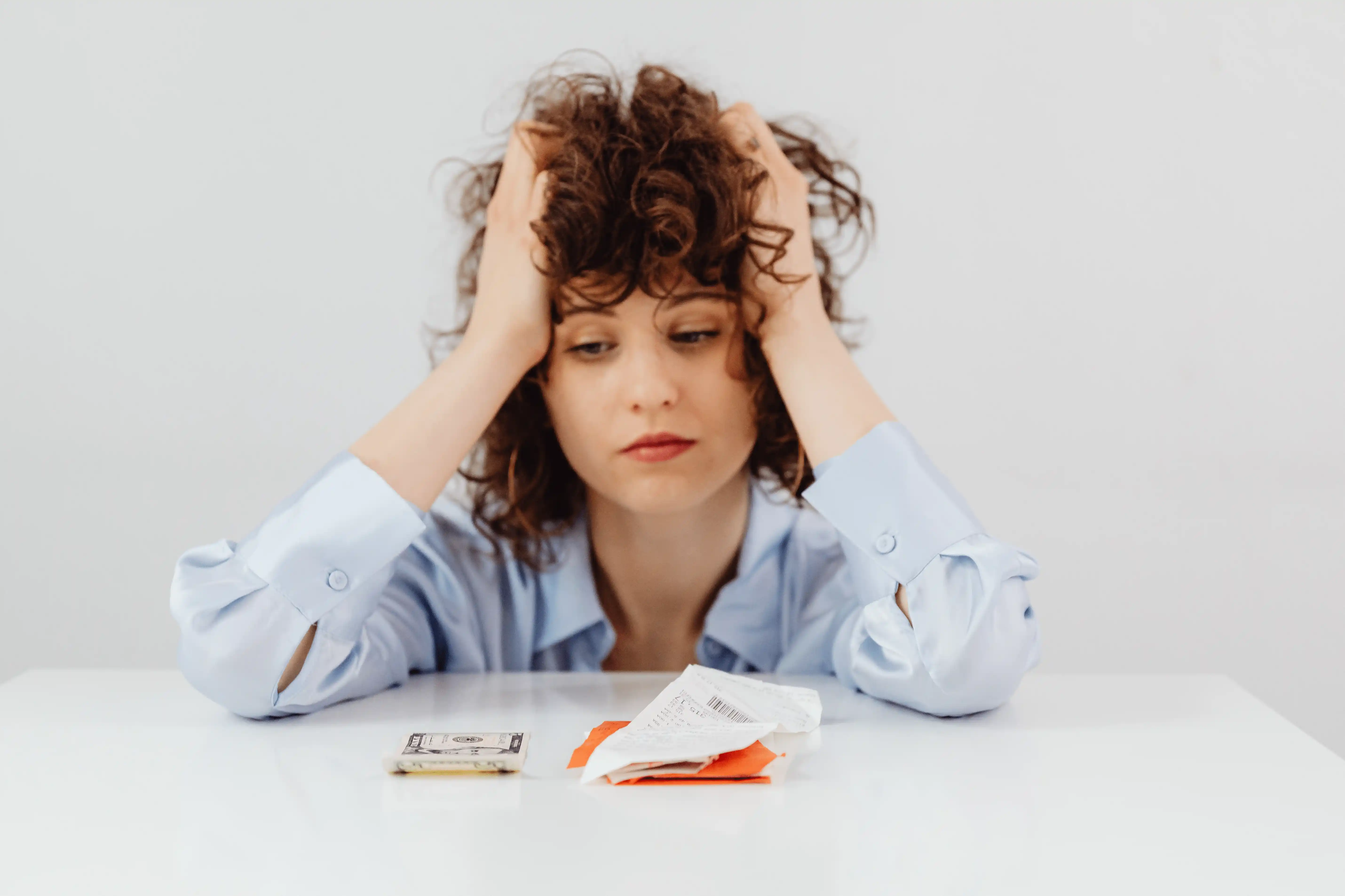 Stressed homeowner reviewing a doubled property insurance premium notice
