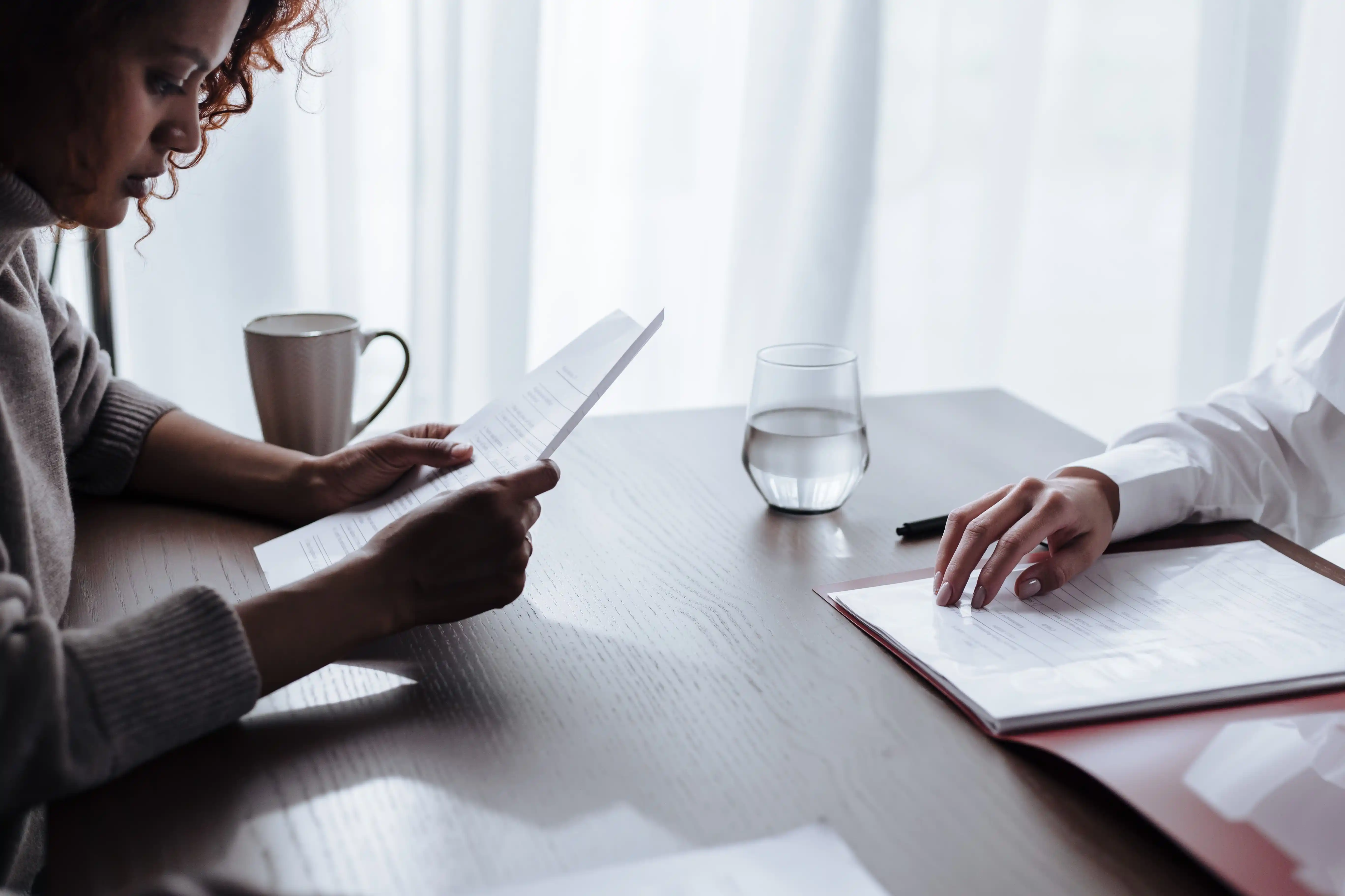 Heirs sitting together at a kitchen table reviewing Oklahoma probate paperwork