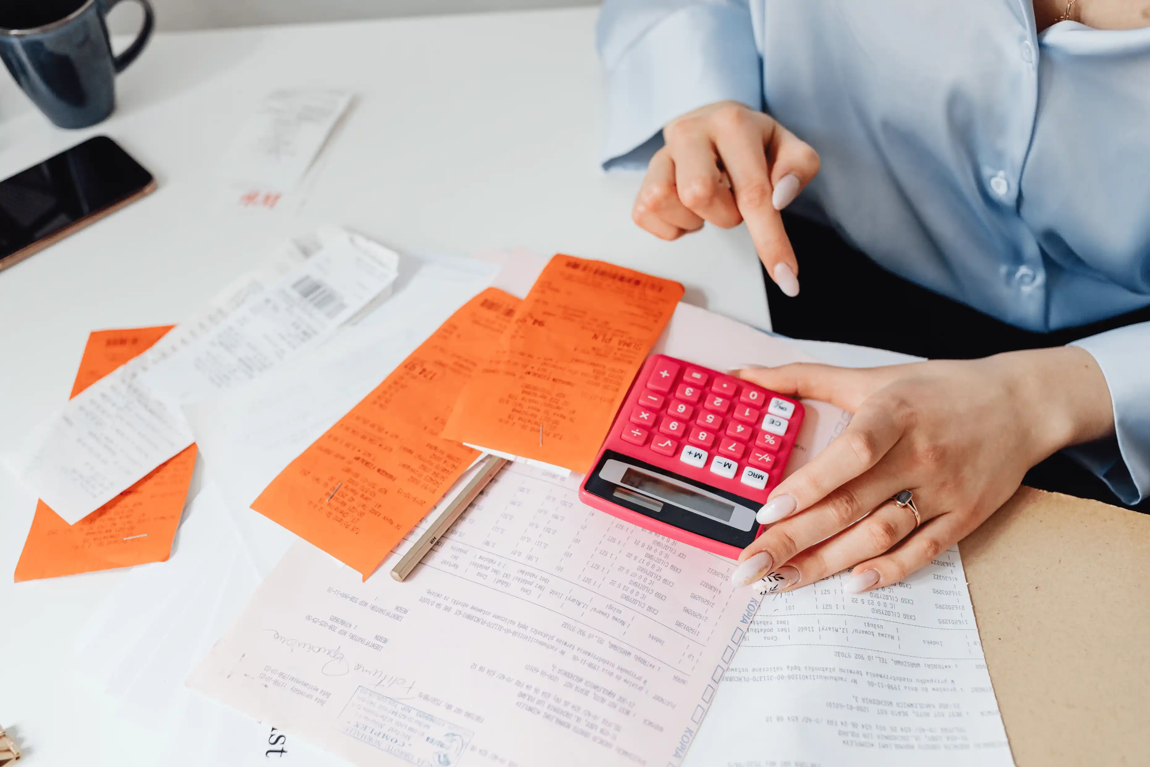A stressed landlord reviewing financial documents and unpaid rent notices