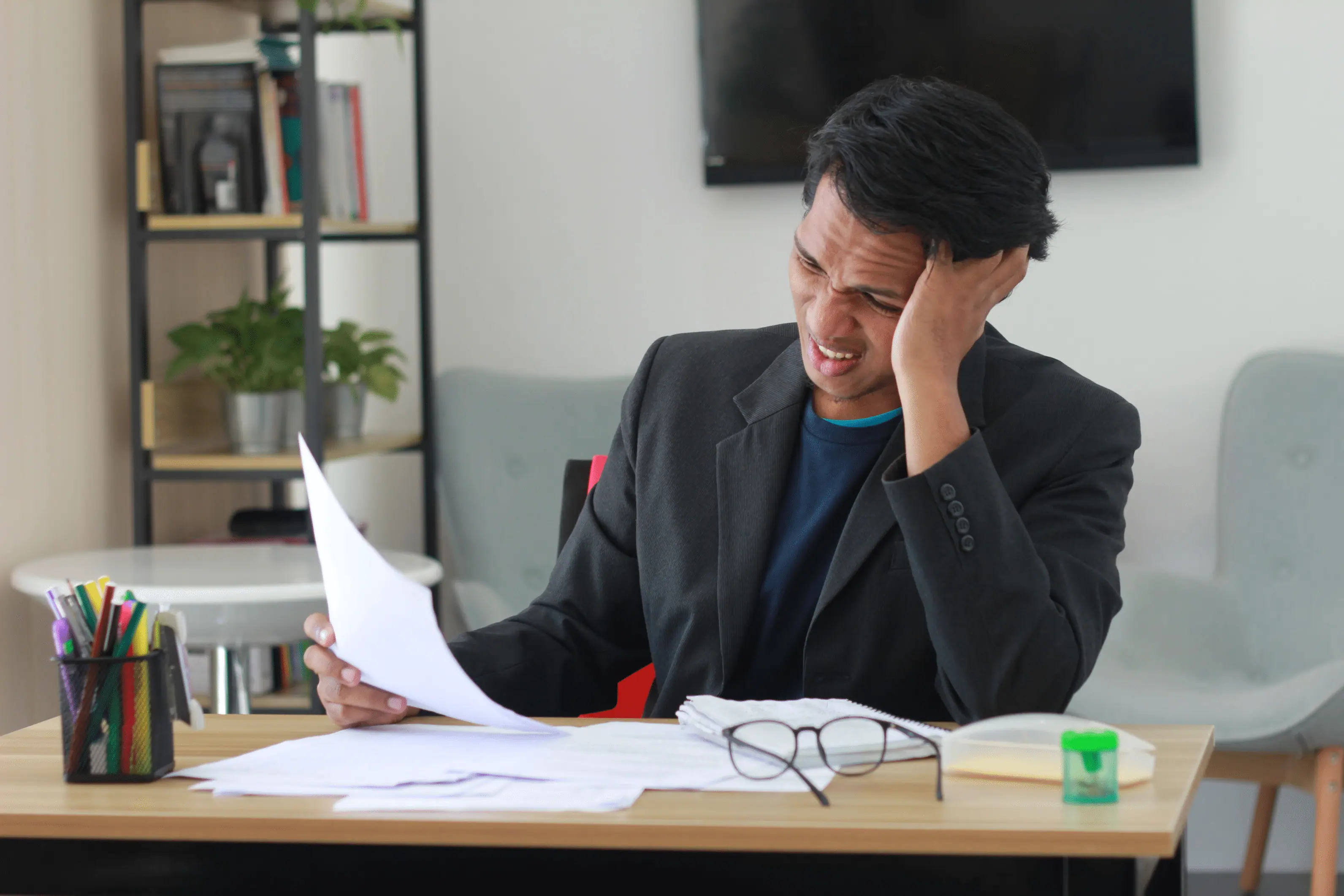 frustrated oklahoma city landlord reviewing section 8 paperwork
