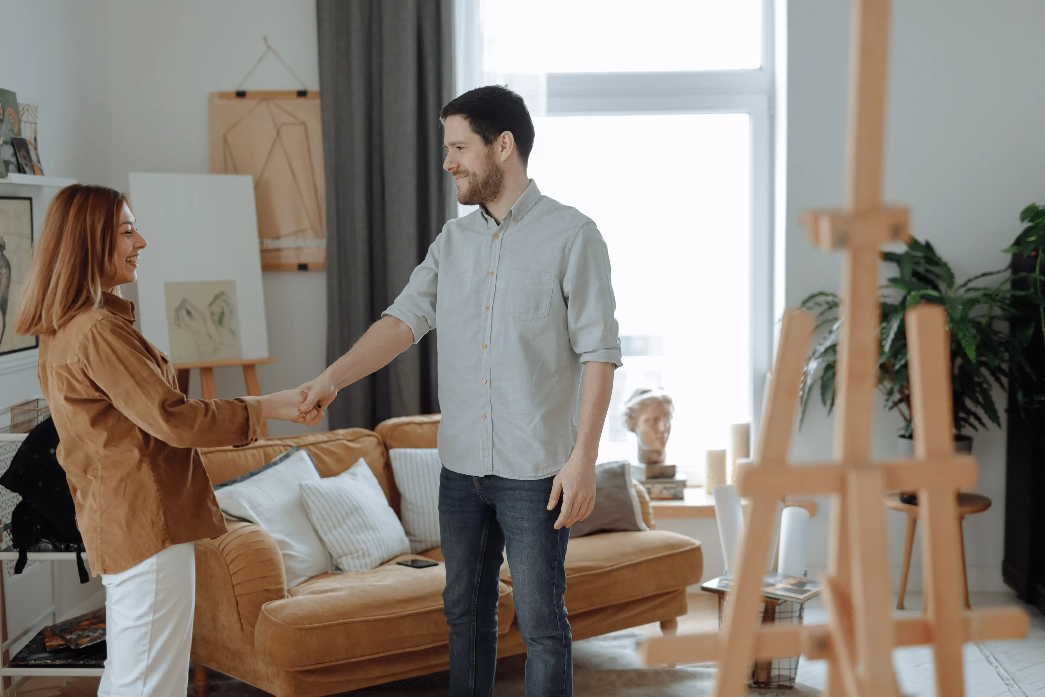 Homeowner and buyer shaking hands after a successful as-is property closing